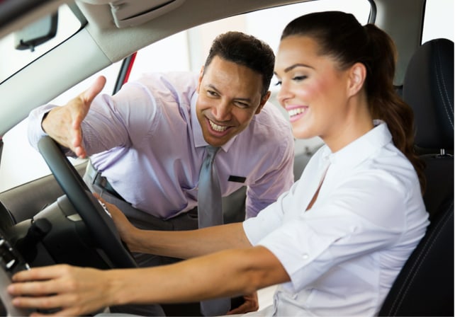 friendly car salesman helping a customer