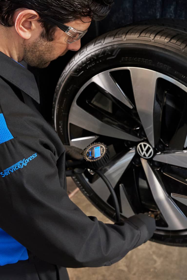 mechanic working on car wheel